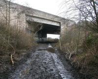View north along the trackbed of the Edinburgh, Loanhead and Roslin Railway in February 2011 between Loanhead and Gilmerton. The substantial modern bridge spanning the abandoned route carries Edinburgh's A720 City Bypass and was brought into use with the new road in late 1988. Final closure of the railway route, latterly serving Bilston Glen Colliery, occurred 6 months later, following closure of the colliery itself. [See image 32922]<br>
<br><br>[John Furnevel 21/02/2011]