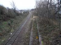 Meadowbank Stadium station had a mayfly existence, being built for the 1986 Commonwealth Games and being served only by specials from Waverley for the Games and for a couple of other events before and after. I remember it appeared on the Abbeyhill loop on the 'ScotRail East Network Map' posted in Haymarket's allocation of Class 101 DMUs, so perhaps it was once the intention to make this a regular stop on North Berwick services. As it was, the line was singled, leaving the only platform high and dry and the connection with Waverley at Abbeyhill Junction was also cut. The existing line though is in regular use by the Powderhall 'Binliners'. Looking towards the junction at Piershill on 12 February.<br>
<br><br>[David Panton 12/02/2011]