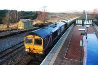 66725 with 6E45 (empty alumina tanks returning to North Blyth) pauses at Rannoch on its way south. The smell from the brakes was rather strong. In the distance the repainted Rannoch Viaduct can be seen in the trees.<br><br>[Ewan Crawford /02/2011]