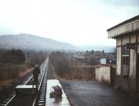 Looking south towards Killin Junction from Killin station in December 1966, fifteen months after the last train ran. Following the discovery of a landslide in Glenogle in the early hours of 27th September 1965, the morning train from Killin had run as usual to Killin Junction, only to find there was no main line train to connect with. The branch train therefore continued to Crianlarich, following which the railway closed completely, five weeks before originally scheduled. [See image 32993]<br>
<br><br>[Frank Spaven Collection (Courtesy David Spaven) /12/1966]