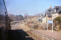 The level crossing and closed station at Achterneed seen from the 10.40 Inverness-Kyle train on Saturday 13th April 1968, as it battles into the 1 in 50 gradient towards the Ravens Rock summit. <br><br>[Frank Spaven Collection (Courtesy David Spaven) 13/04/1968]