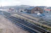 The 1986 Rationalisation commences at Largs. View showing the goods shed and the Clydeside bus garage. The long lye was a carriage siding and used to have a stationary boiler with a wooden cab. In the Railway Magazine it was suggested that it was off a G&SWR Baltic - but it looked too small for that, more likea Jumbo or similar. I wonder if anyone out there knows the truth?<br>
<br><br>[Colin Miller //1986]