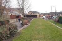 A jogger runs through platform 1 at Bonnyrigg station (closed 1962) heading towards Hardengreen Junction. The former station on the Peebles Loop is now part of a walkway/cycleway (or runway in this case?). View north east towards the B704 on 5 March 2011.     <br><br>[John Furnevel 05/03/2011]