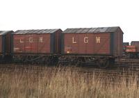 These venerable wooden bodied vehicles were still being used in the early 1970s for the transport of grain between Leith Docks and the North British Distillery maltings at Gorgie [see image 29927]. I notice that wagon No. 120 in the SRPS collection was built for the Leith General Warehousing Co. by Hurst Nelson & Co. of Motherwell in 1903, so presumably No. 99 (on the left) was even older. Photographed at Leith South on 22 November 1970. <br>
<br><br>[Bill Jamieson 22/11/1970]