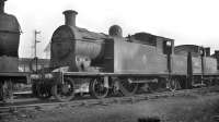 C16 4-4-2T no 67500 stands in the shed yard at 65C Parkhead around 1960. Part of the stand of the former Carntyne stadium (closed 1972) can be seen in the background.<br><br>[K A Gray //1960]