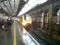 The 16.10 Voyager to Glasgow Central pulls into a damp platform 11 at Crewe on 5th February. (My wife was away, so I was at play.) There were quite a few 56's returned from France in the sidings out of sight in the distance.<br><br>[Ken Strachan 05/02/2011]