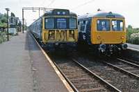 Class 312 EMU meets Class 105 DMU at Kirby Cross on 30th July 1983. A  rare sight on the Thorpe le Soken to Walton on the Naze line, the DMU was forming the Great Eastern railtour which included Sudbury, St Botolphs, Walton on the Naze, Clacton and Felixstowe in its itinerary.<br><br>[Mark Dufton 30/07/1983]