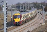 334 025 brings up the rear of a six car train from Helensburgh Central to Edinburgh Waverley on 16 March. The train is passing the site of the former Westcraigs station.<br><br>[Bill Roberton 16/03/2011]