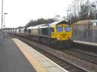 Freightliner 66585 runs through Llanharan Station during the late afternoon on 9 March with the return Port Talbot to Tunstead limestone empties. The loaded outbound service ran through Cardiff Central at 09.00 that morning, being looped before reaching Bridgend to let passenger services pass.<br><br>[David Pesterfield 09/03/2011]