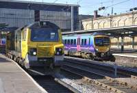First TransPennine 185 139�leaves Carlisle�on 18 March with�the 14.07 Edinburgh Waverley -�Manchester Airport service. Standing at platform 3 is Freightliner 70006 waiting to follow it south.<br><br>[Bill Roberton 18/03/2011]