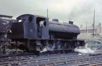 <I>Warspite</I>, one of two Austerity 0-6-0STs that worked at the coal preparation plant before it closed and they were transferred to Whitehaven's Ladysmith Colliery. This loco was fitted with the narrow Giesl ejector funnel but sister engine <I>Amazon</I> had a standard chimney. Driver Raymond Penn, formerly a BR fireman at Carlisle Upperby, is seen in charge of <I>Warspite</I> as it goes about its arduous duties. (With thanks to Steven Oakden for additional information). <br><br>[David Hindle //1968]