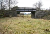 Eastern approach to Symington along the trackbed of the Symington, Bigger and Broughton Railway in March 2011. After passing below this bridge the line swung north to the junction with the WCML at Symington station. The buildings visible through the bridge now occupy the site of the old goods yard, which stood in the V of the junction [see image 22588]. <br><br>[John Furnevel 21/03/2011]