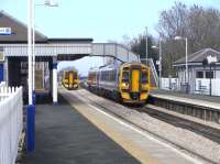 158 734 calls at Dalmeny on 16 March with a returning Fife local. <br>
Heading for the Bridge is a 4-car 158 for Perth which has not called, but is observing speed restrictions caused by recent track replacement. The pristine ballast on either side of the bridge gives this away.<br>
<br><br>[David Panton 16/03/2011]