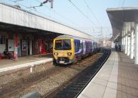 <I>The view from Platform 0</I>. EMU 323235 calls at Platform 1 on its way to Crewe with an all stations stopper. Platform 0 was built in 2004 to ease pressure on the original two island platforms but only used from 2008. <br><br>[Mark Bartlett 24/03/2011]