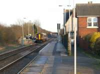 An East Midlands service heading towards Grantham calls at <br>
Bottesford in the late afternoon of 19 March 2011. Footbridges do not seem to feature at many stations in this part of the world and this station also has staggered platforms. A closer examination also shows that a short length of each platform has been raised to a more appropriate height.<br><br>[John McIntyre 19/03/2011]