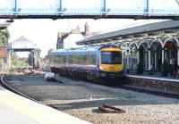 On a warm and sunny Monday morning in September 2008 First TransPennine unit 170307 pulls into the westbound platform at Selby with a Hull - Manchester Piccadilly service. The train has just crossed the River Ouse on Selby swing bridge in the background.<br><br>[John Furnevel 29/09/2008]