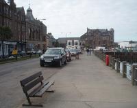 Trains for Machrihanish ran to and from Campbeltown quayside from 1906 onwards connecting with steamers from Glasgow. The road in this picture had two tracks down the middle. Initially successful the <I>Wee Train</I> later struggled against road competition. It didn't reopen for the 1932 summer season and had been dismantled for scrap by 1934. [See image 33469] for a map showing the railway in this part of Campbeltown in 1921 <br><br>[Mark Bartlett 26/03/2011]