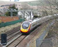 Southbound at Thankerton, some four and a half miles south of Carstairs, on 21 March 2011. The train is the 13.40 Glasgow Central - London Euston Pendolino service. The former station building can be seen above the leading vehicle.    <br><br>[John Furnevel 21/03/2011]