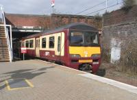 320 310 emerges from under the Bellgrove Street bridge into Bellgrove station on 26 March. The fact that it's a 320 reveals that it's not an Edinburgh service: 334s are reserved for those. In fact it's a Balloch to Airdrie train.<br>
<br><br>[David Panton 26/03/2011]