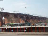 In 1840 Stockport viaduct was the largest viaduct in the world and is still one of the world's largest brick built structures. In the 1890s it was widened for four tracks. A Class 323 EMU is on the up slow lines passing over the River Mersey and Stockport bus station on the approach to Stockport station.<br><br>[Mark Bartlett 24/03/2011]