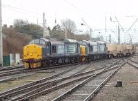 With Arnside viaduct closed for repairs in 2011 traffic for Sellafield is routed via the WCML to Carlisle. DRS Class 37s 37667 and 37194 had a lengthy wait in the loops at Carnforth before getting underway again with the 6C53 Crewe to Sellafield on 1 April. The train comprised seven nuclear flasks and is seen here rejoining the main line immediately south of the station platforms. A further halt in the Oxenholme loops was probably expected by the crew. [Editor's note: No 37667 (then D6851) hauled the last down Anglo-Scottish freight on the Waverley Route (the 08.30 Kingmoor-Millerhill) on Saturday 4th January 1969.]<br><br>[Mark Bartlett 01/04/2011]