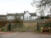 View west from Station Road at the entrance to the former up goods yard at Thankerton, South Lanarkshire, in March 2011. The WCML runs past on the other side of the metal fence and the converted 1848 station building stands beyond. Thankerton station closed to passengers in January 1965. <br><br>[John Furnevel 21/03/2011]