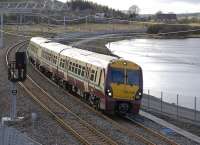 334 030 approaching Forrestfield along the south shore of Hillend reservoir on 2 April with a Helensburgh Central - Edinburgh Waverley service.<br><br>[Bill Roberton 02/04/2011]