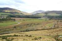 Scene near Broughton on 21 March 2011, with the trackbed of the SB&B running across the centre of the picture. View is south towards Rachan Farm, with the village of Broughton off picture to the right. Meandering alongside the trackbed is the Holms Water, which is about to reach its confluence with the River Tweed, just visible on the far left above the line of trees. Eight miles further to the left, the river, road and railway all arrived at the town of Peebles, eastern terminus of the SB&B [see image 7402]. The line lost its passenger service in 1950 with complete closure east of Broughton in 1954 and the final section between Broughton and Symington in 1966.<br><br>[John Furnevel 21/03/2011]