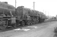BR Standard class 9F 2-10-0 no 92214 in the shed yard at Southall on 20 August 1961. After a period in Barry scrapyard, followed by subsequent rescue and restoration, this locomotive moved to the NYMR in 2010.] [See image 40267]<br><br>[K A Gray 20/08/1961]