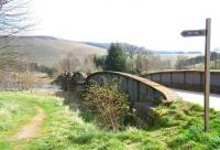 View south across the River Tweed on a warm and sunny 8 April 2011 towards the former station at Cardrona. The converted station building, now a general store, stands just beyond the other end of the bridge. As can be seen from the sign, much of the surrounding area now forms part of the local golf course.<br><br>[John Furnevel 08/04/2011]