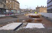 Looking east over the tram/train/bus interchange at Haymarket on 10 April 2011 with Haymarket Terrace on the left. Behind the camera the tracks will dive downhill to parallel the E & G line, crossing it twice on its way to Edinburgh Airport. [See image 30576]<br><br>[Bill Roberton 10/04/2011]