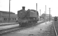 Hawksworth 0-6-0PT no 8422 stands on Southall shed in August 1961. Designed for heavy shunting duties and classified 4F this example was built in 1950 during the BR era. No 8422 spent its last days at Southall, being withdrawn 11 months after this photograph was taken and cut up at Cashmores, Newport in October 1962 after less than 12 years service. Note the old grounded clerestory coach in the background, once a feature on many steam sheds.<br><br>[K A Gray 20/08/1961]