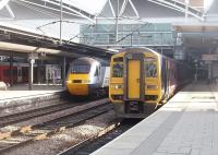 Ready for departure from Leeds are 43316, leading an East Coast HST for Kings Cross, and 158872 on a Calder Valley service for Manchester Victoria. On this Saturday I noticed that, with one exception, every train on a very busy departure board was on time. The only late service was a SW England to Aberdeen train and that was only running 15 minutes late. Northern Rail have had a big push on punctuality recently that certainly seems to be paying off.  <br><br>[Mark Bartlett 19/03/2011]