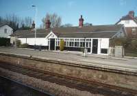 The second station out of Hull on the Selby line is Ferriby where this unusual station building on the eastbound platform is still in commercial use. This picture, taken from a Hull to Sheffield stopping train on 19 March 2011, also shows the through westbound line in the foreground as the platform is on a loop line.<br><br>[Mark Bartlett 19/03/2011]