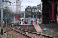 Shawlands station viewed from the bridge over the Barrhead line. The line here looks a little bumpy, but then this is pretty telephoto. I'd never noticed before that many Cathcart Circle stations are built like island platforms on single track railways - one face being straight and the other curved. Then again it is a circle with most stations on curves so I should have thought that through. [See image 7511] for the same view, but considerably less telephoto, 24 years earlier. Building now gone, trains changed.<br><br>[Ewan Crawford 27/03/2011]