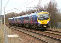 The 12.54 Glasgow Central - Manchester Airport TransPennine Express service runs south through Symington on 21 March 2011. Little remains nowadays to show there was ever a station here, although the distinctive conical hill to the north of the station site continues to provide a link with the numerous photographs taken here in steam days.  <br><br>[John Furnevel 21/03/2011]