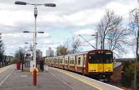 A Newton service (314 201) pauses at Langside station in March 2011. The 1970s 'lego brick' style station building has been replaced by a glass tank. The on-platform fencing, an attempt at 'revenue protection', has also gone. The original station building burned down on the 13th of August 1966 but struggled on for a while.<br><br>[Ewan Crawford 27/03/2011]