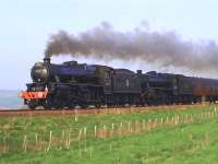 <I>The Great Britain IV</I> racing near Dunning on 20 April behind 45407 + 44871. On this occasion the leading locomotive is carrying the headboard <I>Riley's Whisky Chaser</I>.<br><br>[Brian Forbes 20/04/2011]