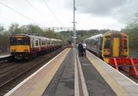 Conversation at Anniesland. The crew of 158738 chat before returning to Glasgow Queen St via Maryhill while 318257 leaves on a service to Milngavie.<br><br>[Mark Bartlett 14/04/2011]