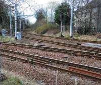 To the left is the line to Neilston and running away to the distance in the centre is the route to Langside. The photograph is taken through a fence at a location which was the trackbed of the Lanarkshire and Ayrshire Railway - this formerly passed Cathcart without being able to take trains from the Langside direction on to Newton as there was only a Neilston to Cathcart spur onto the Cathcart Circle west of the station (the two tracks in the foreground here). Langside to Newton trains were permitted by a new connection from Cathcart West Junction onto the Lanarkshire and Ayrshire and at the same time the 'bypass line' was lifted. [See image 8865] for a view of the former layout.<br><br>[Ewan Crawford 27/03/2011]