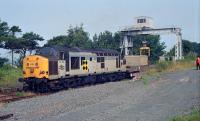 A nuclear flask is delivered by 37165 to the crane at Fairlie (High) during the summer of 1990. This traffic now runs to Hunterston (low level) sidings.<br><br>[Ewan Crawford //1990]