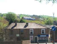 Having just left Colne station and crossed the viaduct the 13.50hrs to Blackpool South service runs across the high embankment that dominates the west end of the town. Colne station, a terminus since 1970, is a mere shadow of its former self [See image 17150] and nowadays only sees this basic hourly service. <br><br>[Mark Bartlett 27/04/2011]