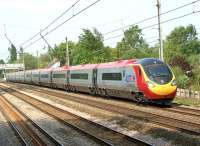 The new 11 car <I>'Extendolino'</I> 390054 heads south at Euxton on 29 April 2011 with the 5T35 service to Edge Hill following a test run between Carnforth and Carlisle earlier in the day.<br>
<br><br>[John McIntyre 29/04/2011]