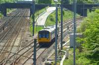 A class 142 unit comes out of the sun as it drops down off the East Lancs line towards Farington Curve Junction and the WCML. The train is an afternoon Colne - Blackpool South service on 30 April 2011.<br>
<br><br>[John McIntyre 30/04/2011]