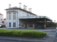 Originally opened in 1840 as Cardiff Docks, the station was renamed Cardiff Bute Road in 1924 before eventually settling for its current name, Cardiff Bay, in 1994. The disused original station building and large canopy are seen looking north over Hemingway Road on 19 April 2011. The present day single bay platform is located beyond the north end of the building running parallel with Bute Street [see image 33846].<br><br>[David Pesterfield 19/04/2011]