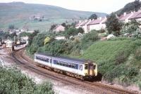 A Manchester Victoria - Huddersfield DMU seen shortly after leaving Marsden station in July 1992.<br><br>[Ian Dinmore /07/1992]