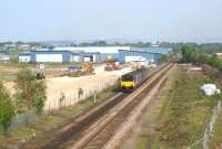 A Northern DMU service heads east towards Chorley on 29 April <br>
2011, passing the site of the new Buckshaw Parkway station. Due to be completed in early October, the new station will be adjacent to the site of the former Chorley Halt [see image 20909]. Work started here early in 2011 and has progressed from the north side of the line (left) where the station building and car park will be located, to the south side, where an access road has been constructed and fencing erected. <br><br>[John McIntyre 29/04/2011]