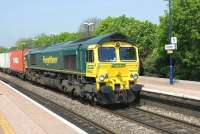 Freightliner 66543 brings an eastbound container train through Cholsey on 21 April 2011.<br><br>[Peter Todd 21/04/2011]