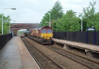 66095 accelerates 13 of the new bitumen tankers through Lostock Hall station with the return empties working from Preston Dock to Lindsey near Immingham. <br><br>[Mark Bartlett 06/05/2011]