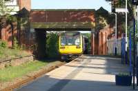 A Blackpool South to Colne service departs from St Annes station under an ornately decorated overbridge on 3 May 2011. On the left are the remains of the old Preston bound platform.<br>
<br><br>[John McIntyre 03/05/2011]